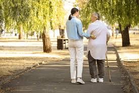 companion walking outdoors with a senior for gentle support